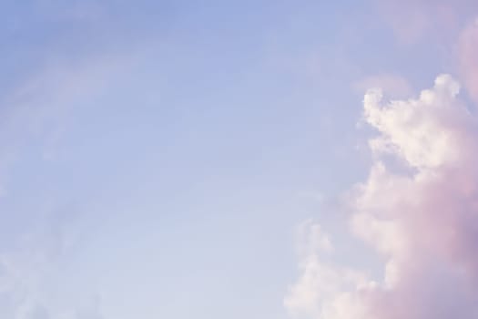 Background of blue sky with pale pink clouds in sunset