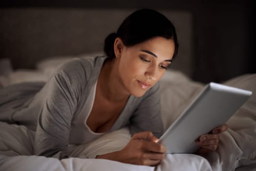 House, bedroom and woman reading with tablet on app, online with connection to internet. Night, female person and girl download ebook for romance with technology to relax on bed, break and weekend.