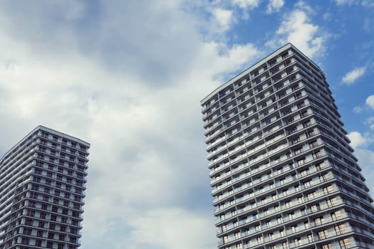 Minsk, Belarus - August  2019. Two modern apartments buildings on a blue sky background. 