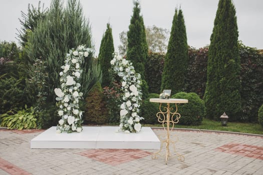 wedding arch of flowers on a green background. wedding ceremony