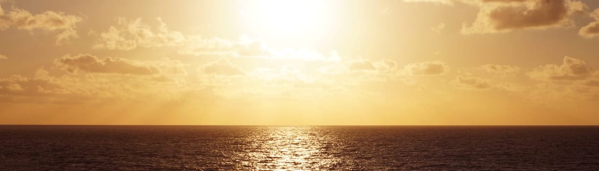 sea horizon with reflecting sun, sea panorama in brown tone.