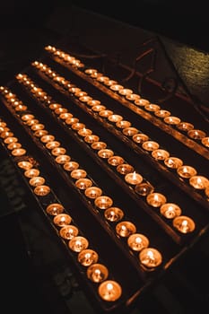 many burning candles in the Church