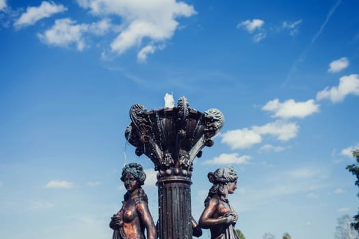 vintage bronze fountain on blue sky background