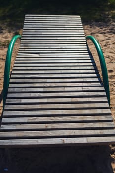 empty wooden beach lounger in summer beach