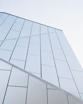 Modern architectural details. Metallic silver facade on sky background