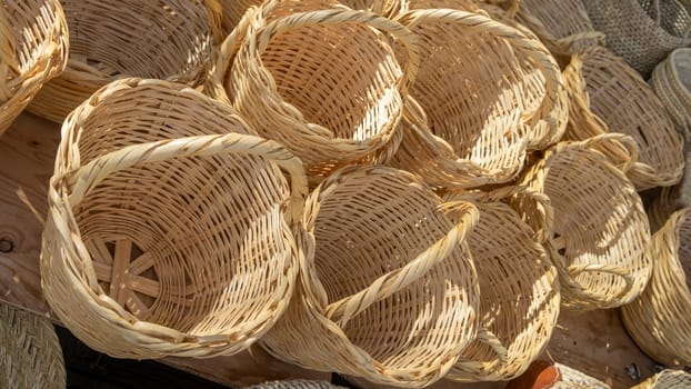 Various handcrafted wicker baskets showcased outdoors.