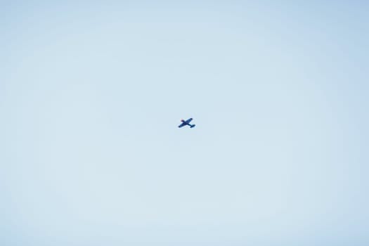 small private plane flying in the blue sky