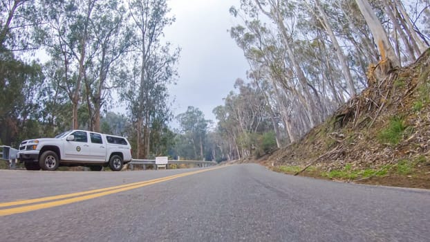 Santa Maria, California, USA-December 6, 2022-In this serene winter scene, a vehicle carefully makes its way along Los Osos Valley Road and Pecho Valley Road within Montana de Oro State Park.