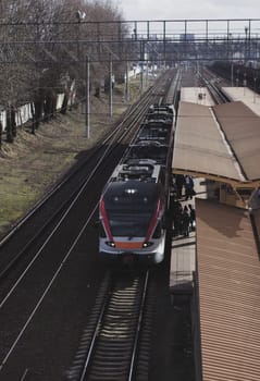 passengers at the railway station enter in modern train