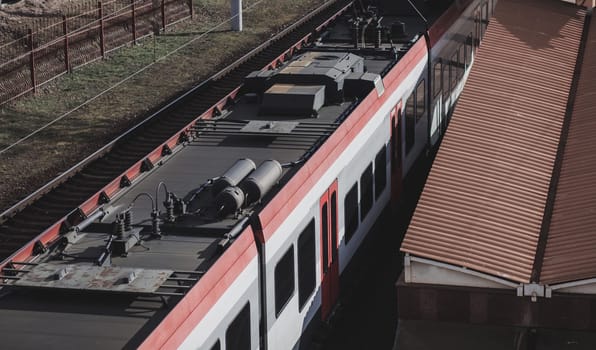 modern european train departing from the railway station in the suburbs