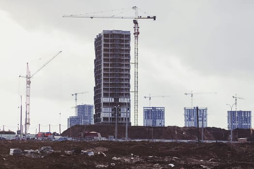 Construction site with cranes of a modern apartment building.
