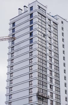 Facade of a multi-storey building with crane