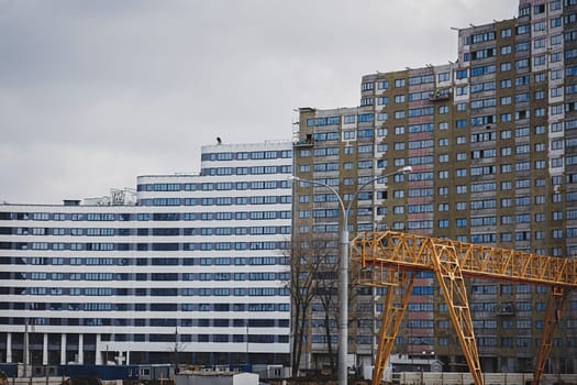 Construction site background. Crane and new multi-storey buildings.