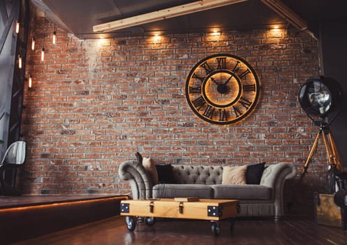 Loft style sitting-room brick and clocks
