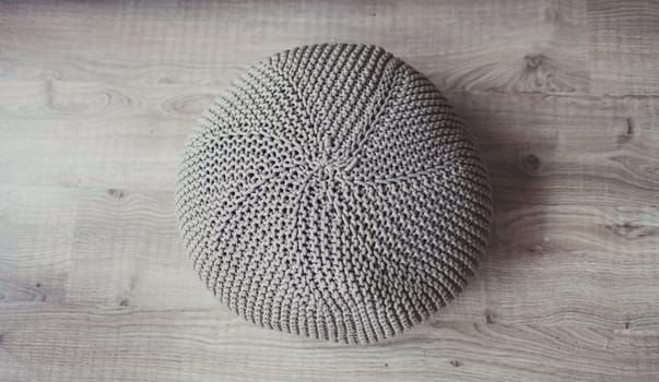 Natural round pouf cushion chair on floor. Minimalist loft coffee shop, restaurant