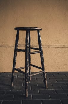 antique shabby wooden chair against the wall