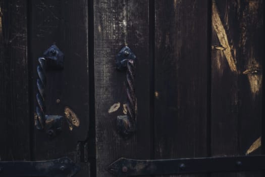 old vintage wooden door with metal handles