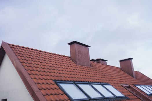 tiled roof with attic and chimney of the old town