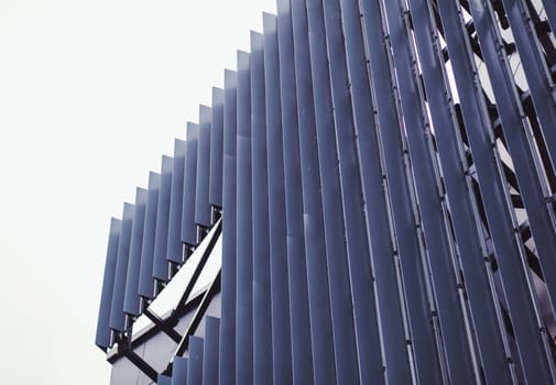 Vertical ,metallic wall panels. Fragment of minimalist business building interior.