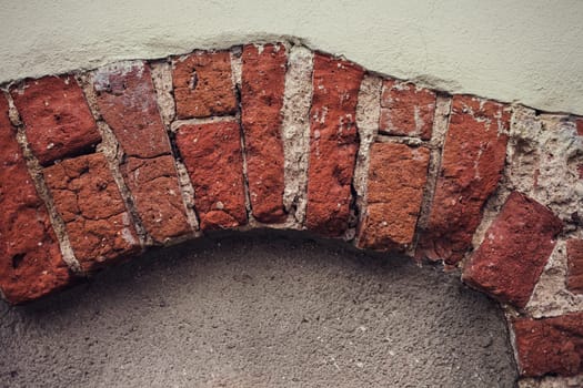 old wall with convex bricks. European building