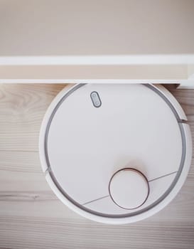 Robotic vacuum cleaner working on laminate top view