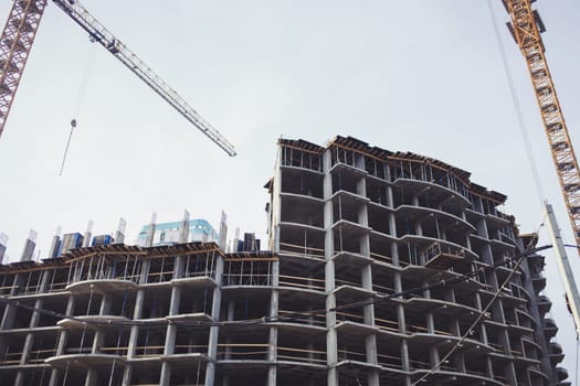 two tower crane on the construction site of a new home. housing loan. mortgage