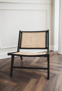 stylish wicker chair in the classic interior of the apartment