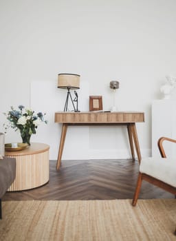 wooden table with a lamp in a white loft minimalist interior. Real photos.