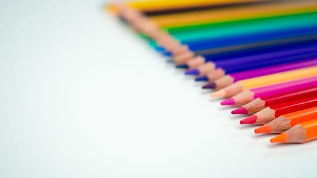 Set of colored pencils on a white background That is arranged in a bar graph, Color pencils on white background, Close up, seamless colored pencils row with wave on lower side, line pencils.