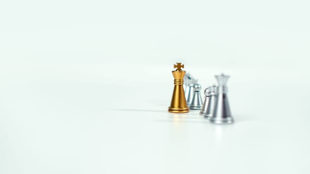 Golden king chess on the board in front of silver chess pieces on white background with copy space, Leadership, fighter, business leadership, competition, confrontation, and business strategy concept.