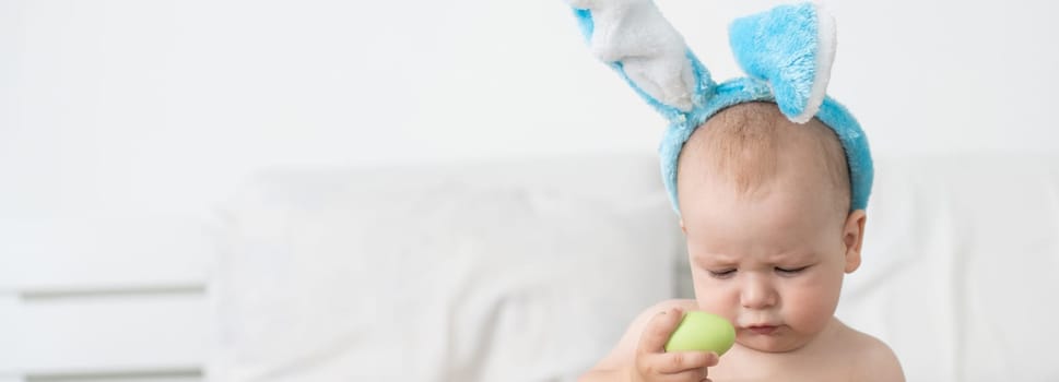 Newborn baby girl in a rabbit ears. Easter Holiday.