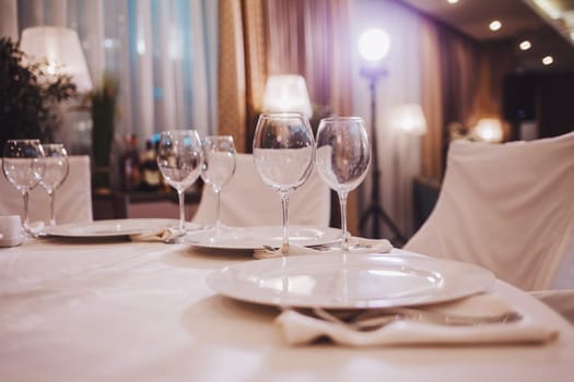 champagne glasses and plates in the restaurant. wedding dinner