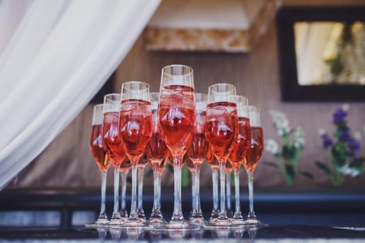 many glasses of wine are on the table in the restaurant