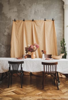 Rustic living room. Wooden vintage table with chairs in the dining room