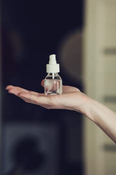 hand with an alcohol-based hand-washing spray as a preventive hygiene measure against coronavirus. Antibacterial hand sanitizer gel.