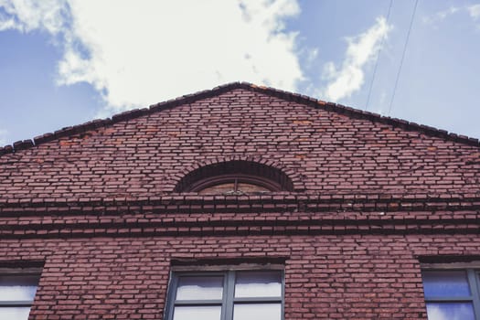 Administrative building. Brick building with windows on sky background.