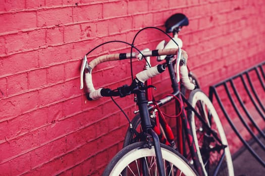 two vintage bicycle parking against colorful wall in city