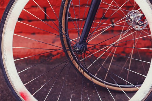 close-up of a vintage bicycle wheel in an urban environment