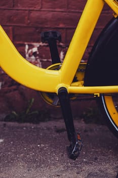 black pedals of an old yellow vintage bike