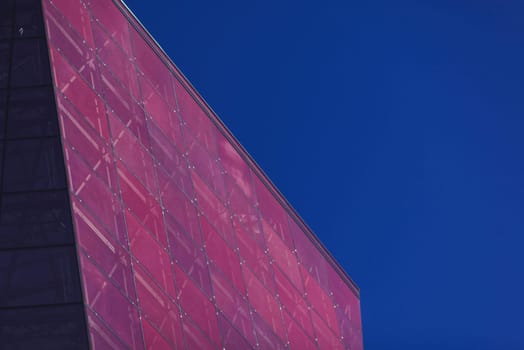 modern urban architecture. red office glass building against the sky
