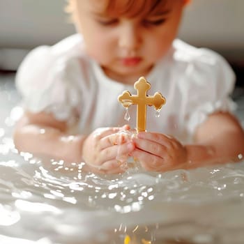 Baptism of a child cross in hands. Selective focus. Kid.