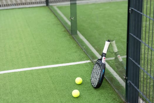 White professional paddle tennis racket with natural lighting on blue background. Horizontal sport theme poster, greeting cards, headers, website and app. High quality photo