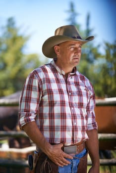 Farm, thinking and senior cowboy on ranch with lasso for horse, cows and rodeo animals for agriculture. Farming, nature and mature man in environment, countryside and working outdoors in Texas.