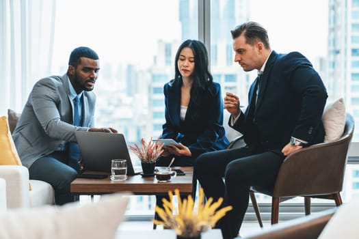 African businessman present start up project to expert investor. Group of multicultural business team solving problems, discussing business idea with skyscraper at modern business lounge. Ornamented