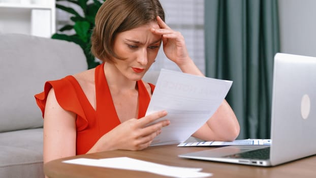 Stressed young woman has financial problems with credit card debt to pay prim from bad personal money and mortgage pay management crisis. Woman worry about financial bankruptcy risk from over spending