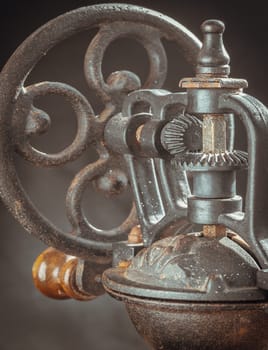 Detail of Antique coffee bean original grinder metal shake wheel with hand crank. Close-up of Old original coffee grinder, Space for text, Selective focus.