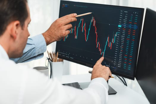 Stock trader pointing highest stock market to present coworker on dynamic valued analysis research on real time monitor screen, cooperating business investment in financial company exchange. Sellable.