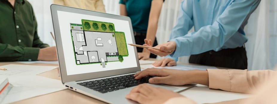 Professional architect decide the blueprint for eco-friendly house during discussion about changing blueprint plan at meeting table with architectural document scatter around. Closeup. Delineation