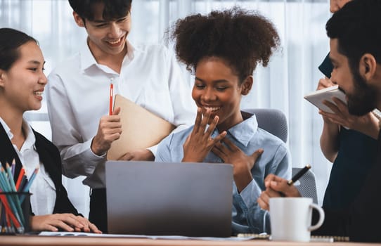 Happy diverse business people work together, discussing in corporate office. Professional and diversity teamwork discuss business plan on desk with laptop. Modern multicultural office worker. Concord