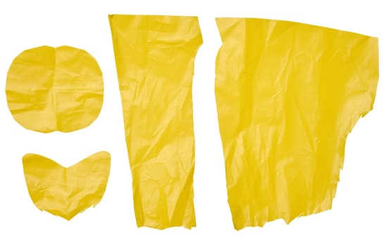 Various yellow polyethylene pieces on isolated background, close up